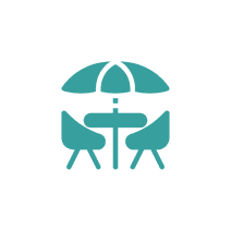 Icon of outdoor table and chairs setup.