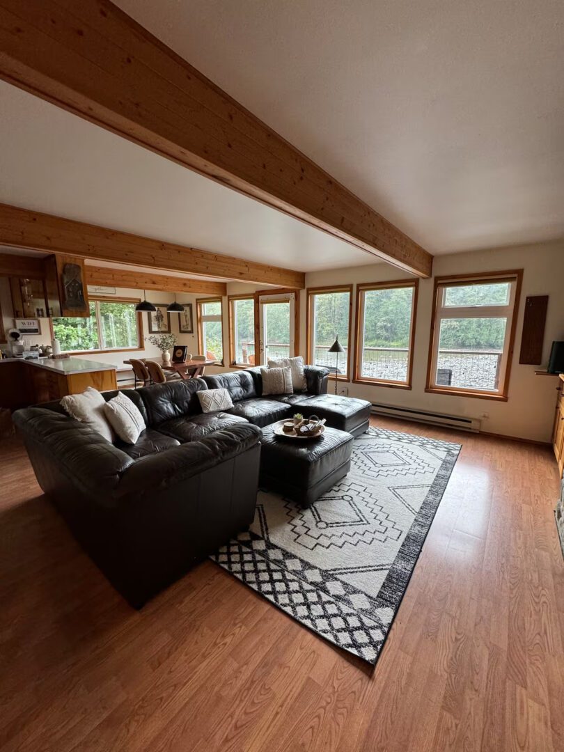 Spacious living room with large windows and modern furniture.