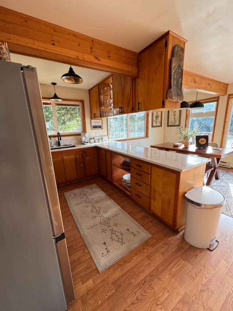 Cozy wooden kitchen with natural light and rustic decor.